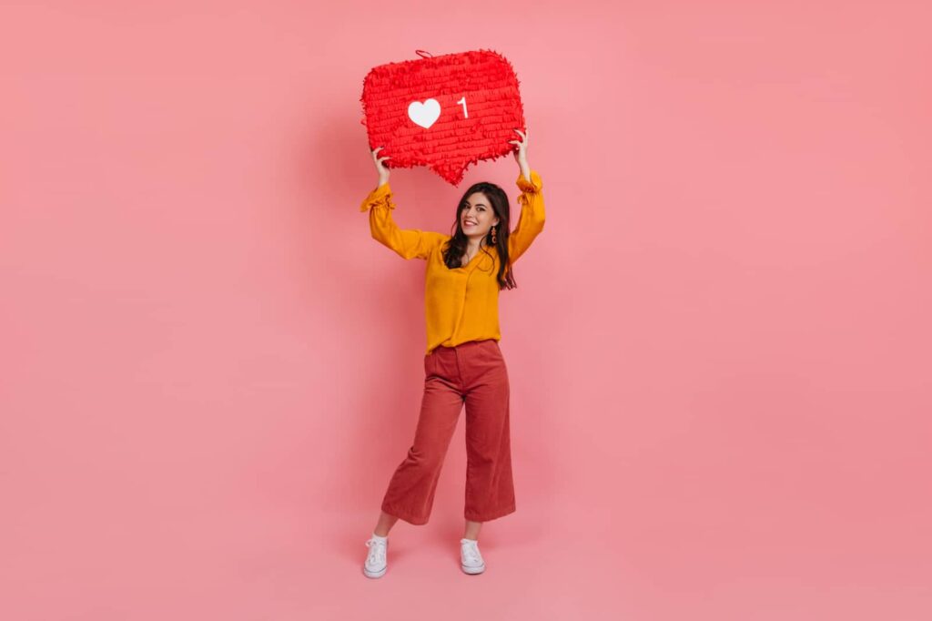 Girl holding an Instagram "Heart" sign.