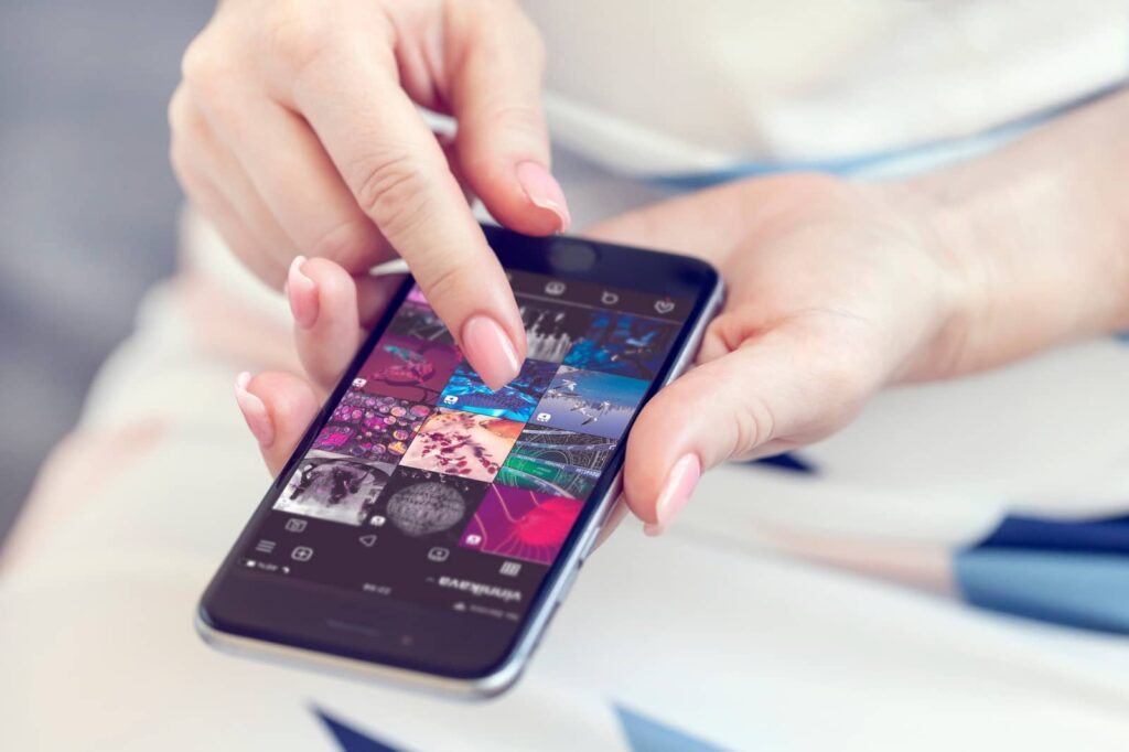 Woman touching a smartphone.