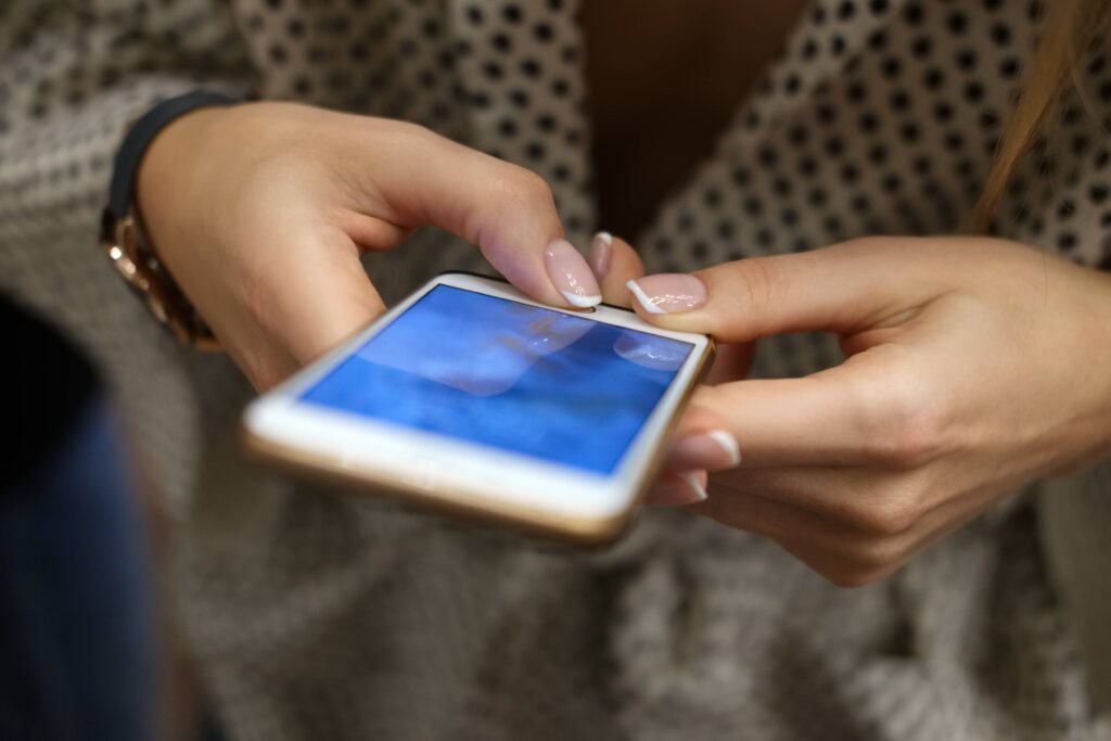 Girl holding mobile phone.